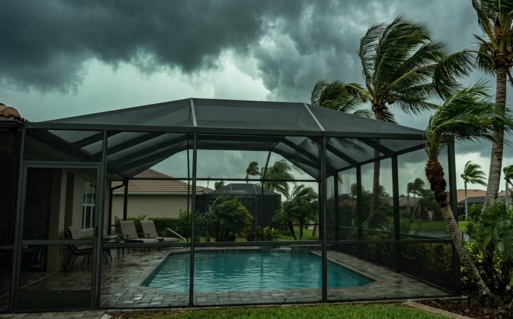 ackyard swimming pool with a screened aluminum pool cage